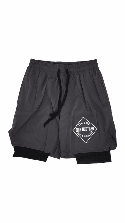 2 in 1 Compression Shorts, grey nylon, and compression shorts with an embroidered logo for active individuals with side hustles. comfortable  and stylish hustle apparel.
